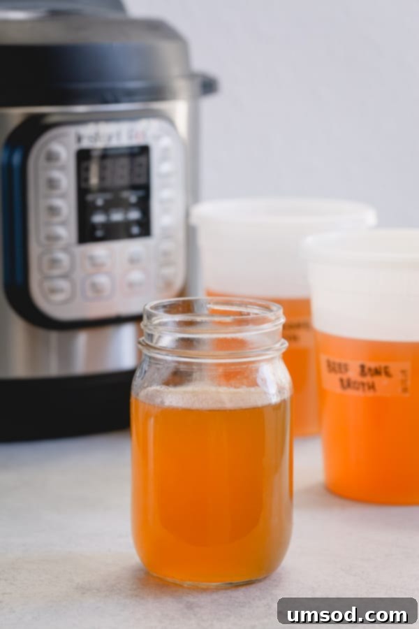 The Essential Guide to Beef Bone Broth 3 Jars of homemade beef bone broth stored in the freezer, ready for use in various recipes.