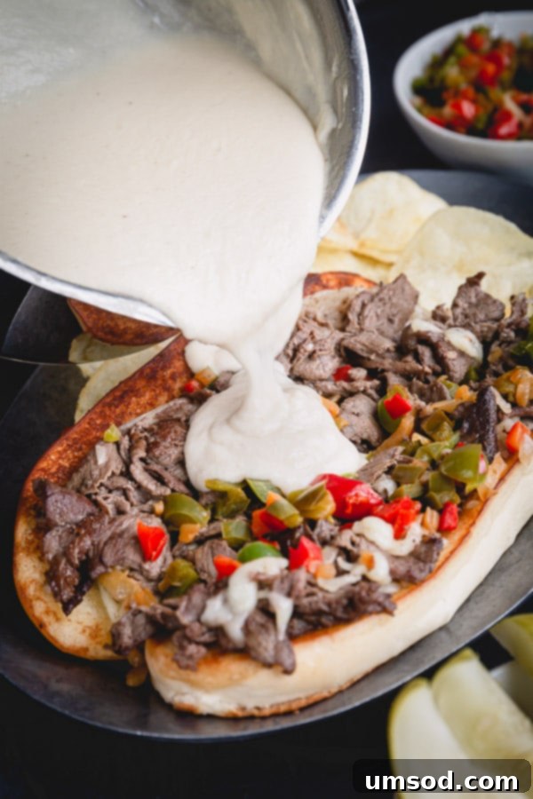 Creamy smooth and flavorful provolone cheese sauce for Philly cheesesteak sandwiches.