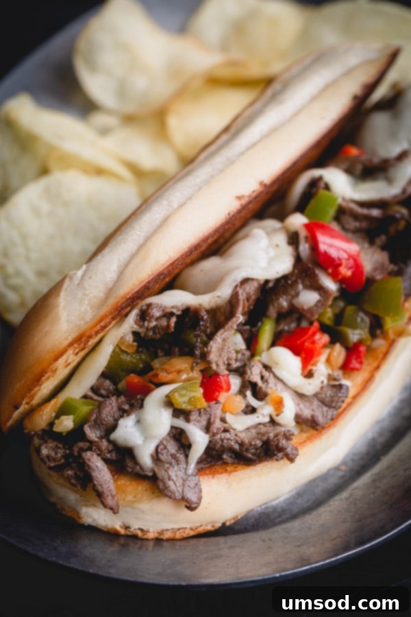Super quick and easy Philly cheesesteak recipe with indulgent provolone cheese sauce, perfect for a special weeknight meal.