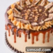 Chocolate Peanut Caramel Dream Cake 18 A whole Snickers cake decorated with caramel sauce, ganache and slices of snickers bar.
