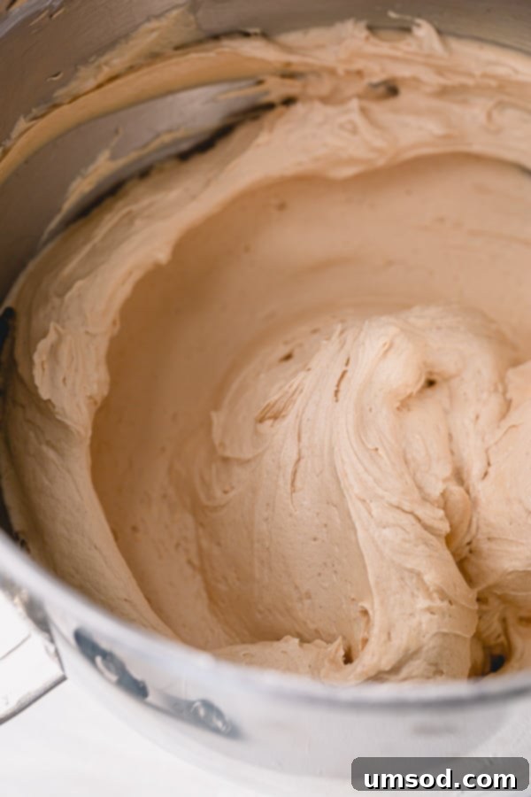 Peanut Butter Buttercream 3 Close-up of fluffy peanut butter buttercream frosting, perfect for cakes and cupcakes. A simple recipe for delicious homemade frosting. #peanutbutter #frostingrecipe #dessertlove #baking