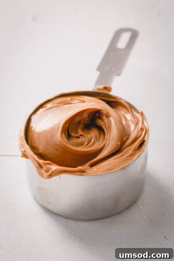 Peanut Butter Buttercream 4 Ingredients for peanut butter buttercream, showing creamy peanut butter and unsalted butter. Essential tips for selecting the best peanut butter for frosting. #bakingtips #peanutbutterlover #frostingingredients