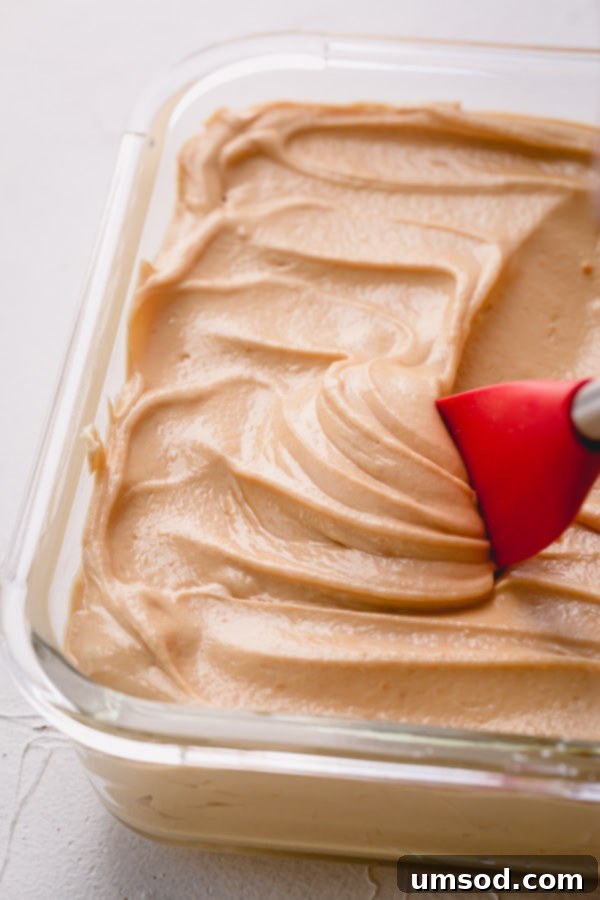 A batch of freshly made salted caramel buttercream frosting, showcasing its smooth and pliable texture.