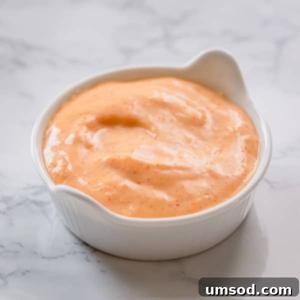 Dip into Delight: 5 Mouthwatering Sauce Recipes 8 Creamy horseradish mayo sauce in a white bowl, garnished with a sprinkle of smoked paprika for extra flavor.