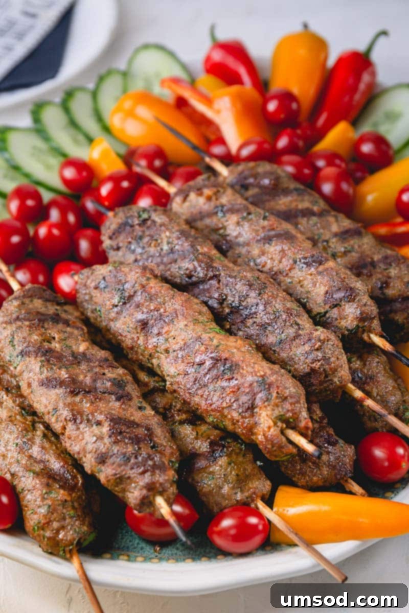Urfa Kebab Excellence 7 A beautifully plated serving of grilled Urfa kebabs, garnished with fresh tomatoes, cucumbers, and herbs