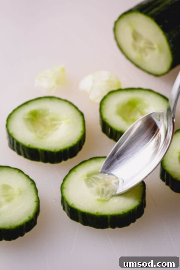 Cucumber slices being prepared for the appetizer, with the centers scooped out.