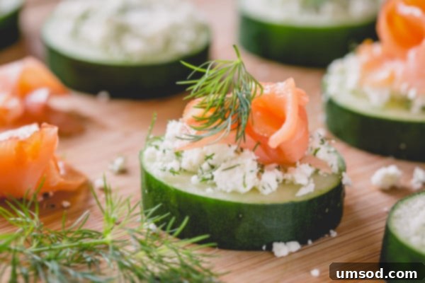 A close-up of a perfectly assembled smoked salmon cucumber bite, ready to be enjoyed.