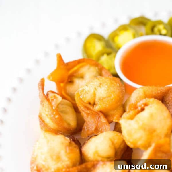 Super crispy wontons with smooth cream cheese filling with a kick. Homemade version of your favorite take-out appetizer with the same irresistibly delicious and addicting taste! Plus, a video tutorial on how to fold wontons 4 different ways.