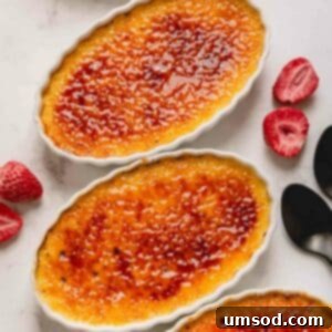Four individual ramekins of classic crème brûlée, each boasting a perfectly torched, amber caramelized sugar crust.
