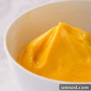 A bowl of light and airy French buttercream, showcasing its smooth texture and readiness for piping onto delicate pastries.