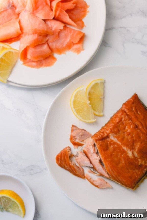 Cold vs Hot Smoked Salmon: A Deep Dive 3 Close-up of delicately sliced cold-smoked salmon, showcasing its glistening, translucent texture and rich pinkish-orange hue, ready for a gourmet appetizer.