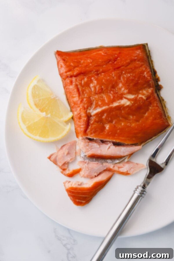 Cold vs Hot Smoked Salmon: A Deep Dive 7 A beautifully presented plate of dill crepes filled with a creamy sauce and topped with elegant slices of cold-smoked salmon, garnished with fresh dill sprigs.