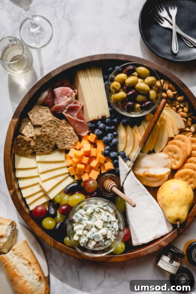 Crafting the Ultimate Charcuterie and Cheese Board 2 Beautifully arranged charcuterie and cheese board featuring a rich assortment of cheeses, cured meats, fruits, and nuts