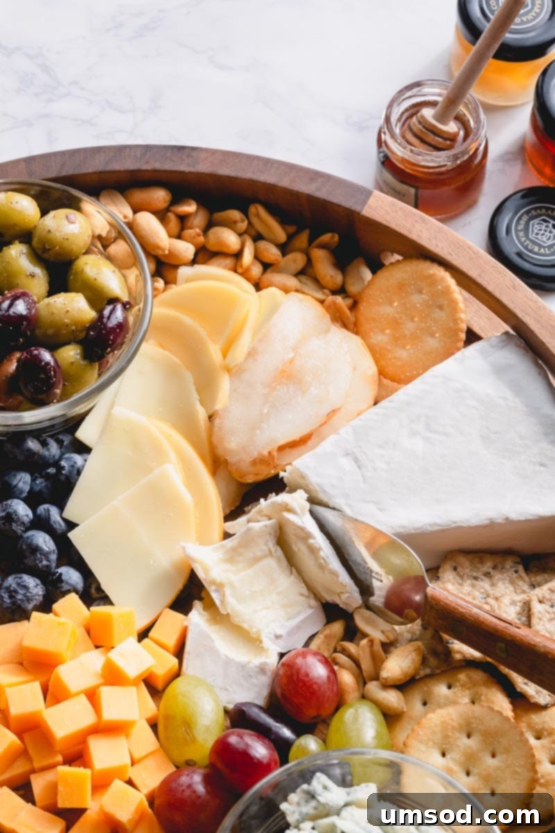 Crafting the Ultimate Charcuterie and Cheese Board 6 Assortment of cheeses unwrapped and left to breathe on a wooden surface, preparing for a charcuterie board