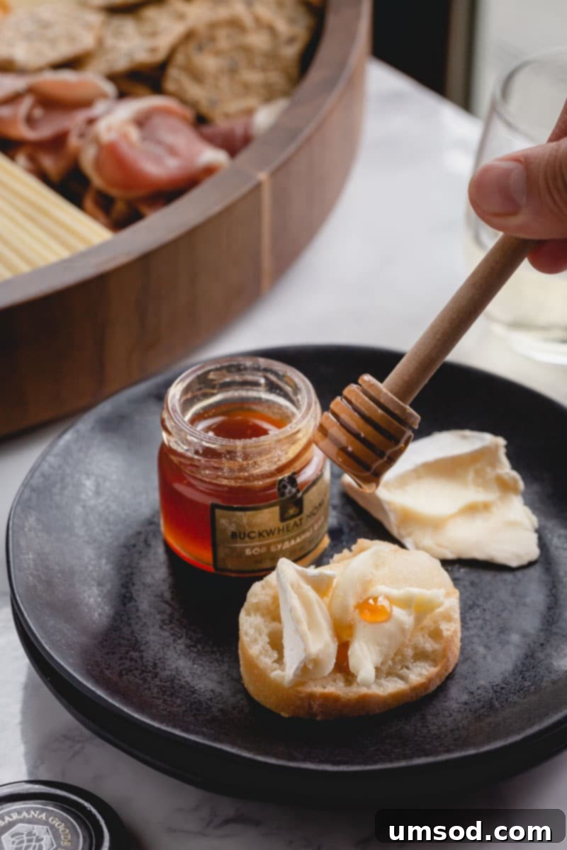 Crafting the Ultimate Charcuterie and Cheese Board 7 A diverse selection of charcuterie board accompaniments, including fresh fruits, various nuts, crispy crackers, and olives, beautifully arranged