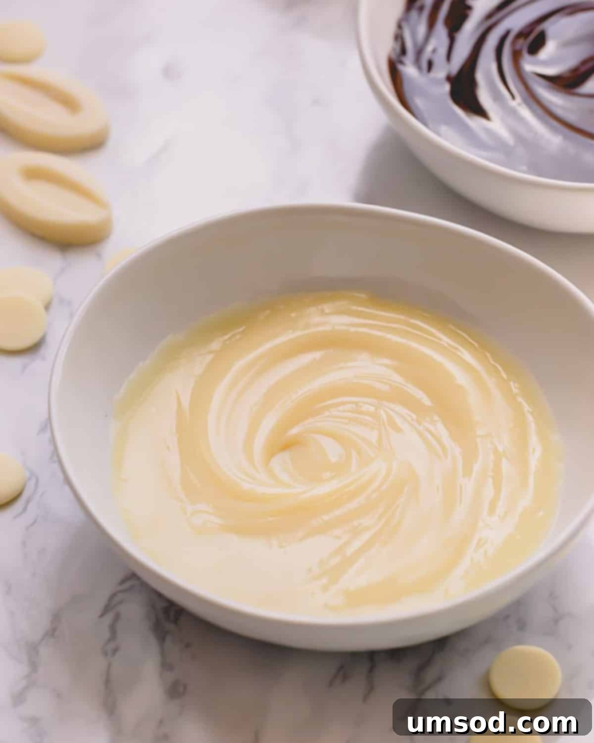 Glossy white chocolate ganache in a white bowl.