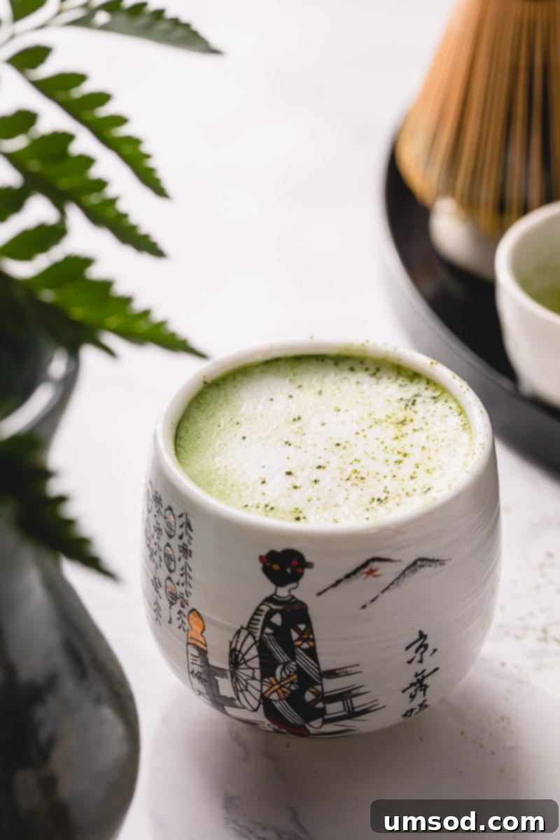 Mastering the Matcha Latte 2 A vibrant green matcha latte served in an elegant cup, inviting a moment of tranquility.