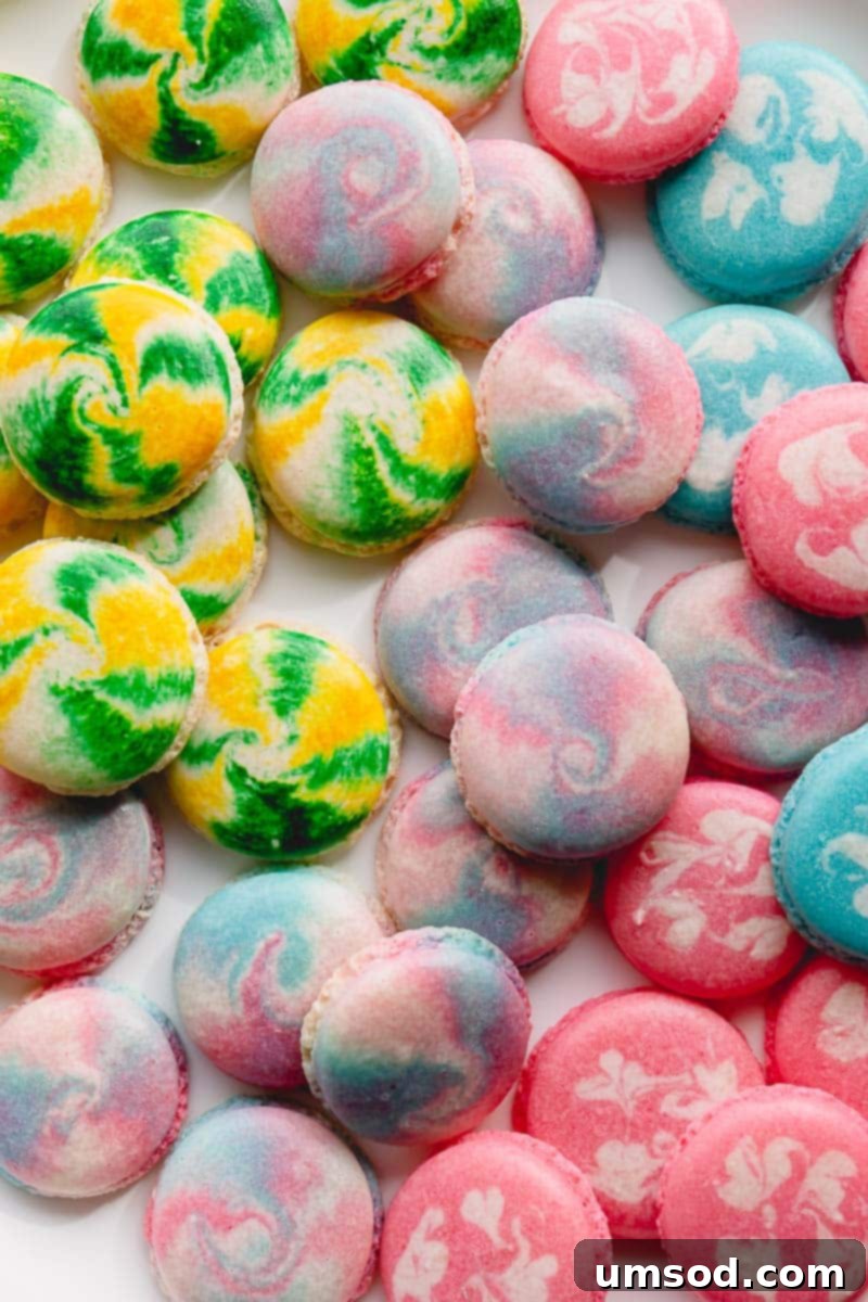 Close-up of three beautifully marbled macarons, showcasing intricate color patterns.