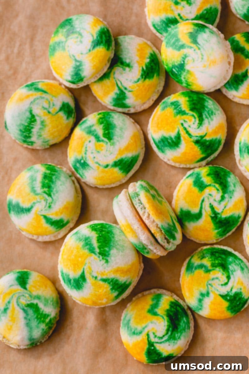 A stunning array of finished marbled macarons with various fillings, ready for enjoyment.