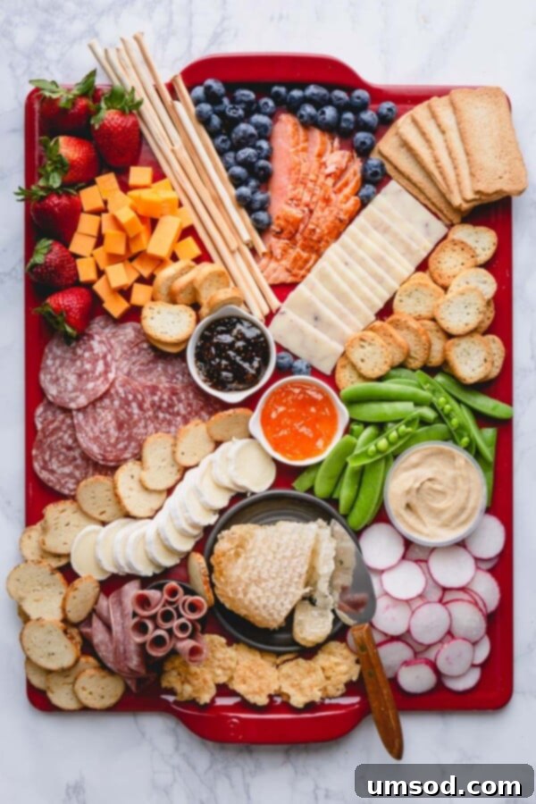 The charcuterie board in progress, with cheeses thoughtfully placed as the first step.