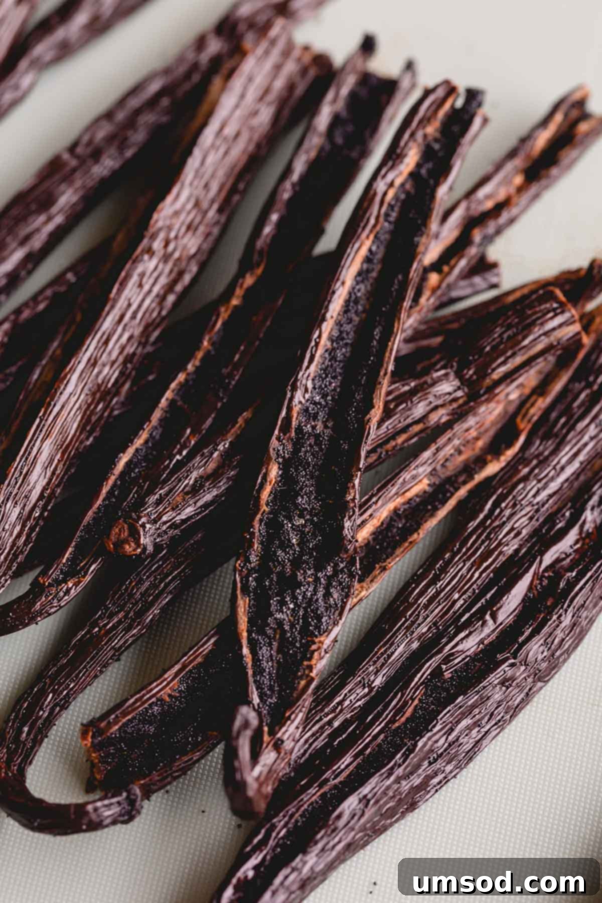 Crafting Your Own Vanilla Extract 4 Vanilla beans sliced lengthwise, revealing the rich, dark caviar inside.