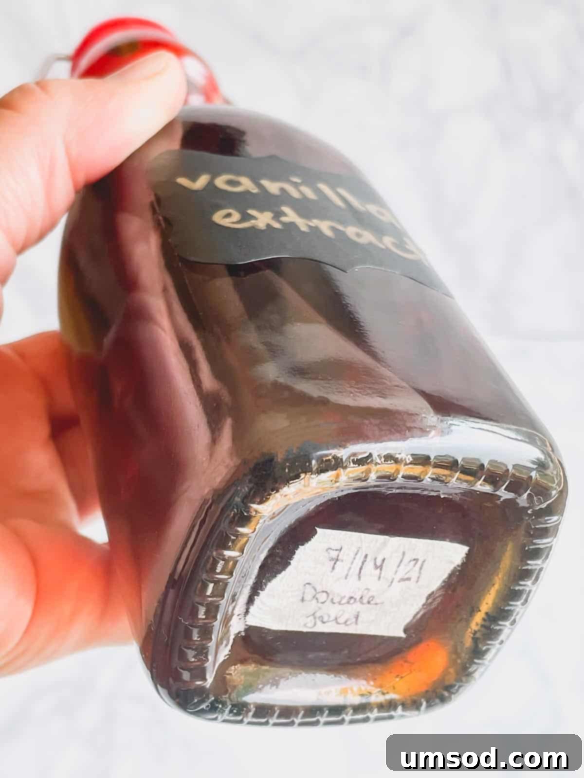 Crafting Your Own Vanilla Extract 7 A clear glass bottle of vanilla extract with a date label on the bottom.