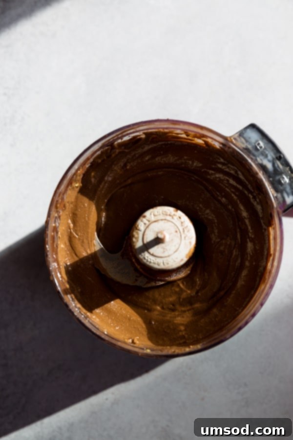 Smooth avocado chocolate mousse in a glass, ready to be topped.