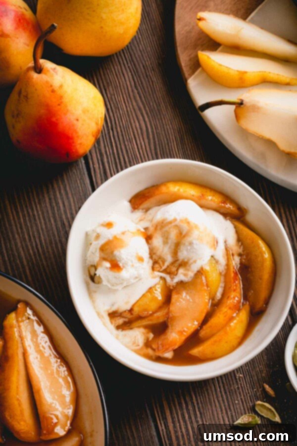 Caramelized pear slices with vanilla ice cream in a small bowl.