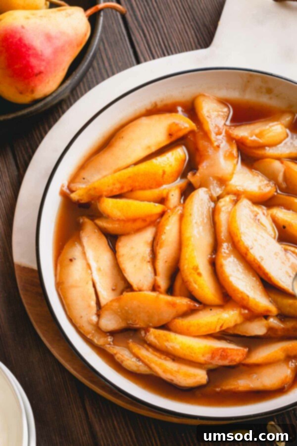Caramelized pear slices with sauce in a white plate.