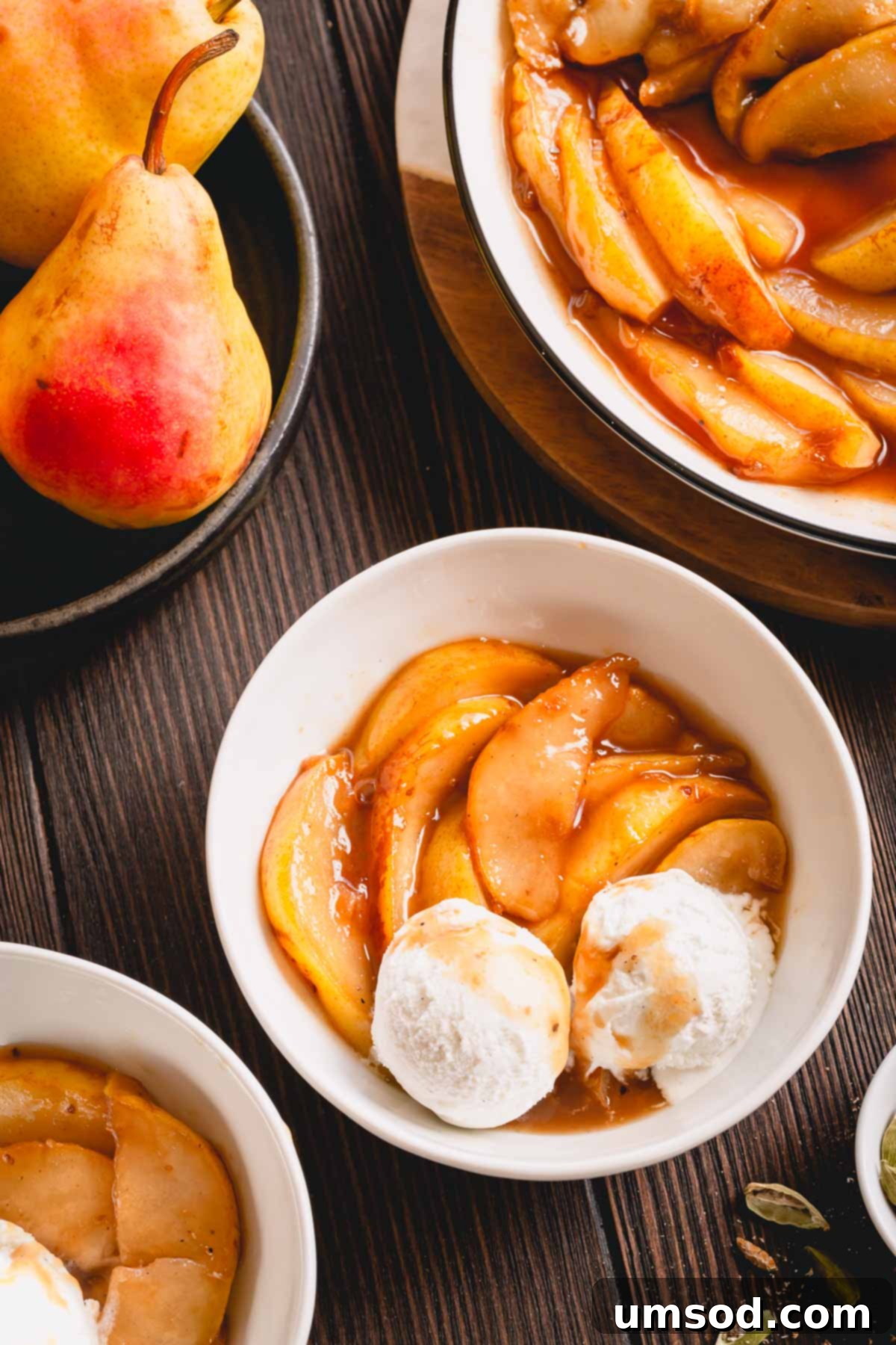 Caramelized pear slices with vanilla ice cream in a small bowl.