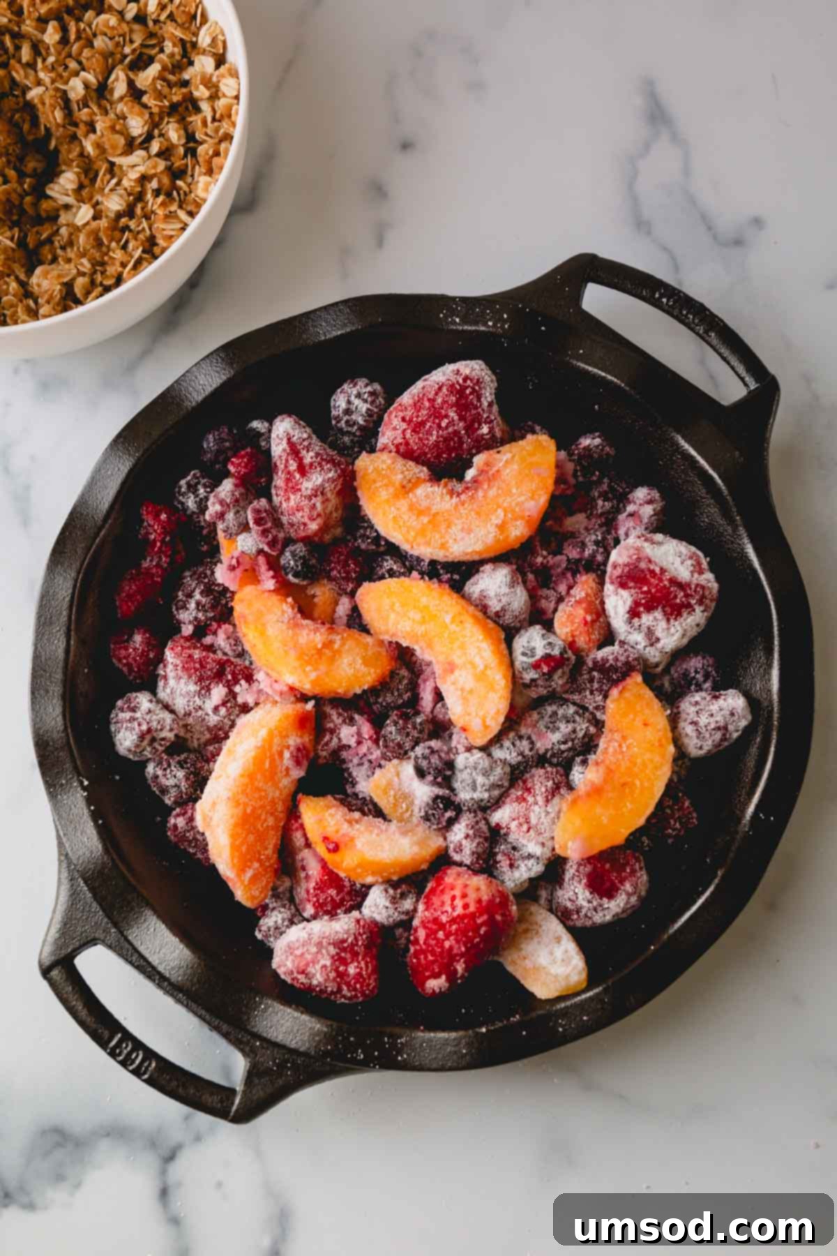 Quick Fruit Crisp 5 Overhead image of frozen mixed fruits in a large baking dish.
