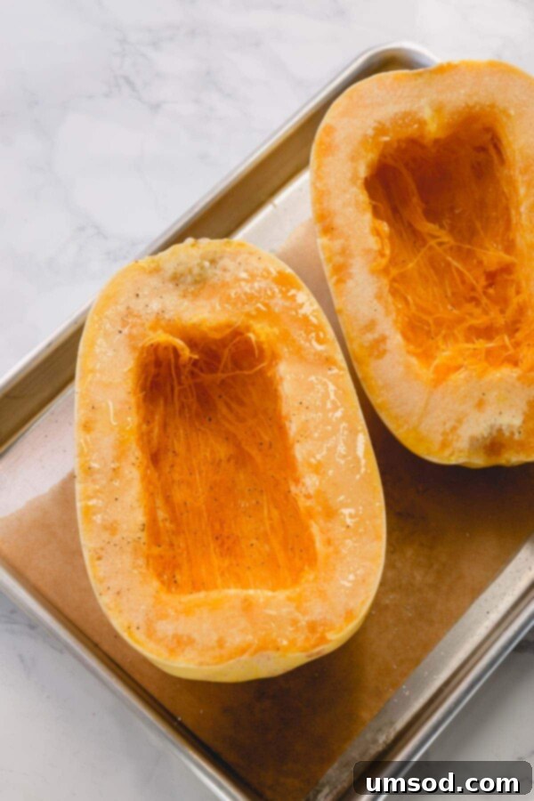 Spaghetti Squash Made Easy: Two Delicious Ways 4 2 halves of spaghetti squash on a baking sheet.