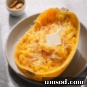 Spaghetti Squash Made Easy: Two Delicious Ways 9 Half of baked spaghetti squash with butter and parmesan cheese.
