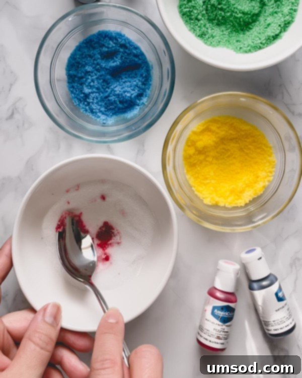 The process of mixing gel food coloring into granulated sugar until evenly colored.