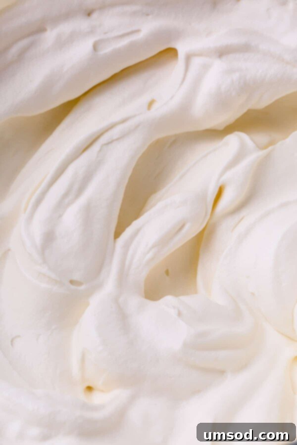 Close-up image of fluffy white tiramisu cream filling, highlighting its smooth and airy texture.