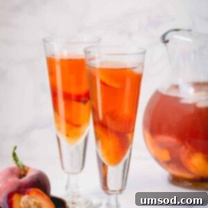 Peachy Keen Iced Tea 6 Two glasses of homemade peach iced tea, garnished with peach slices and mint.