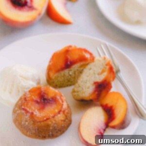 Caramelized Peach Upside-Down Cupcakes 8 Peach upside down mini cakes on a white serving plate with vanilla ice cream and sliced peaches.