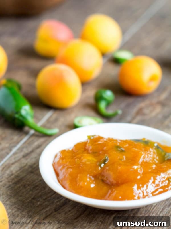 Honey-sweetened apricot jam in a jar, with a deeper golden color.