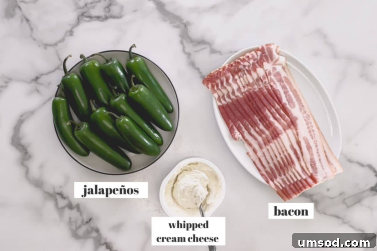 Close-up of the three essential ingredients: fresh jalapenos, a block of cream cheese, and strips of bacon, ready for preparation.
