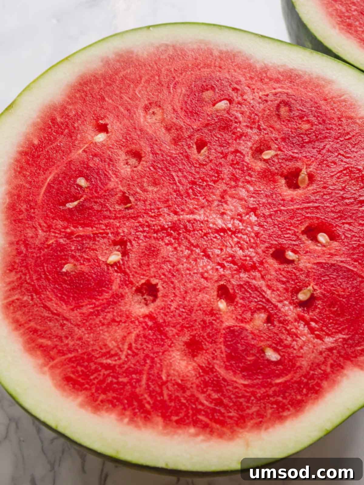 Choose the Best Watermelon Every Time 4 Sliced watermelon half featuring a bright red seedless flesh.