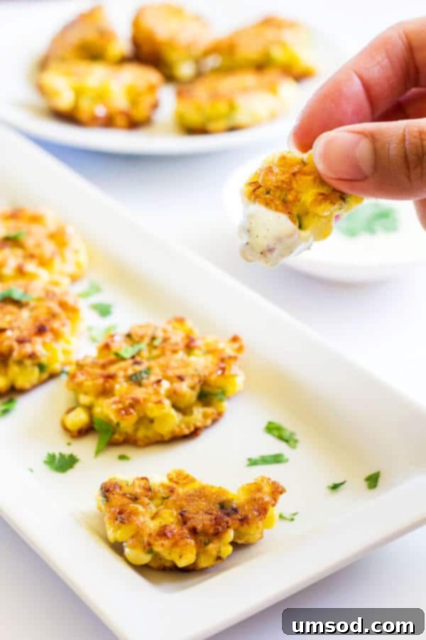 Golden Sweet Corn Bites 5 Close-up of crispy sweet corn fritters ready to be served, showcasing their golden-brown perfection.