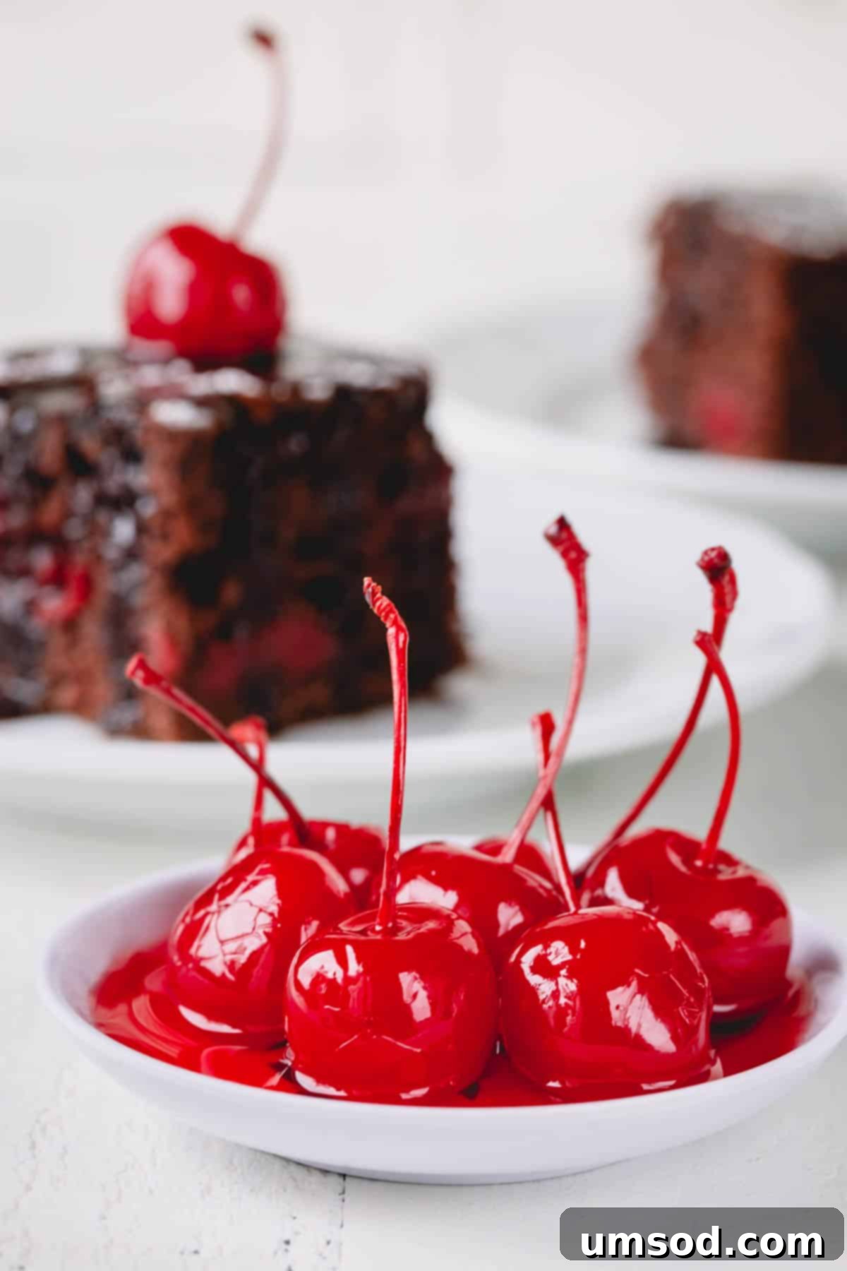 Cherry Essentials 7 A small, elegant plate featuring a handful of vibrant red maraschino cherries.