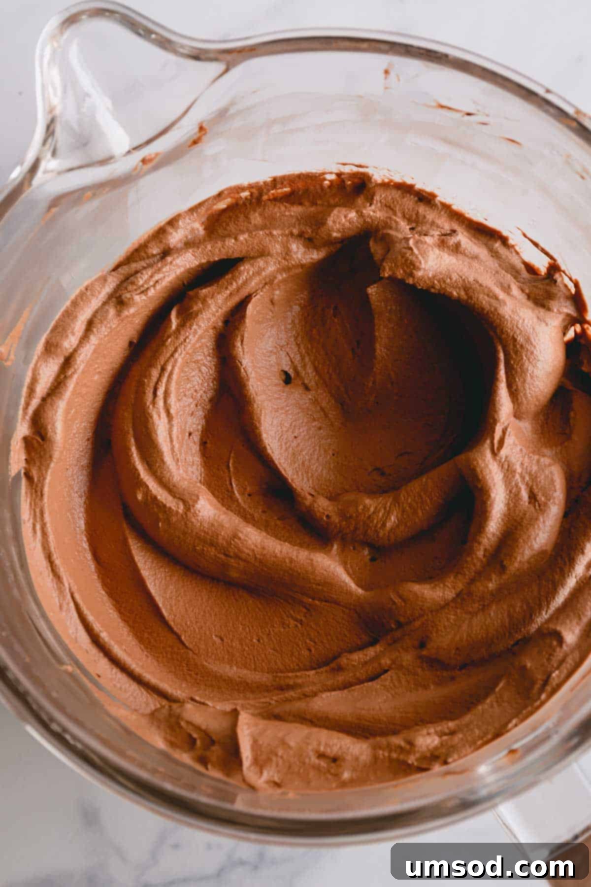 Decadent Chocolate Mousse 2 Silky smooth chocolate mousse filling resting in a clear glass mixing bowl, ready to be used.