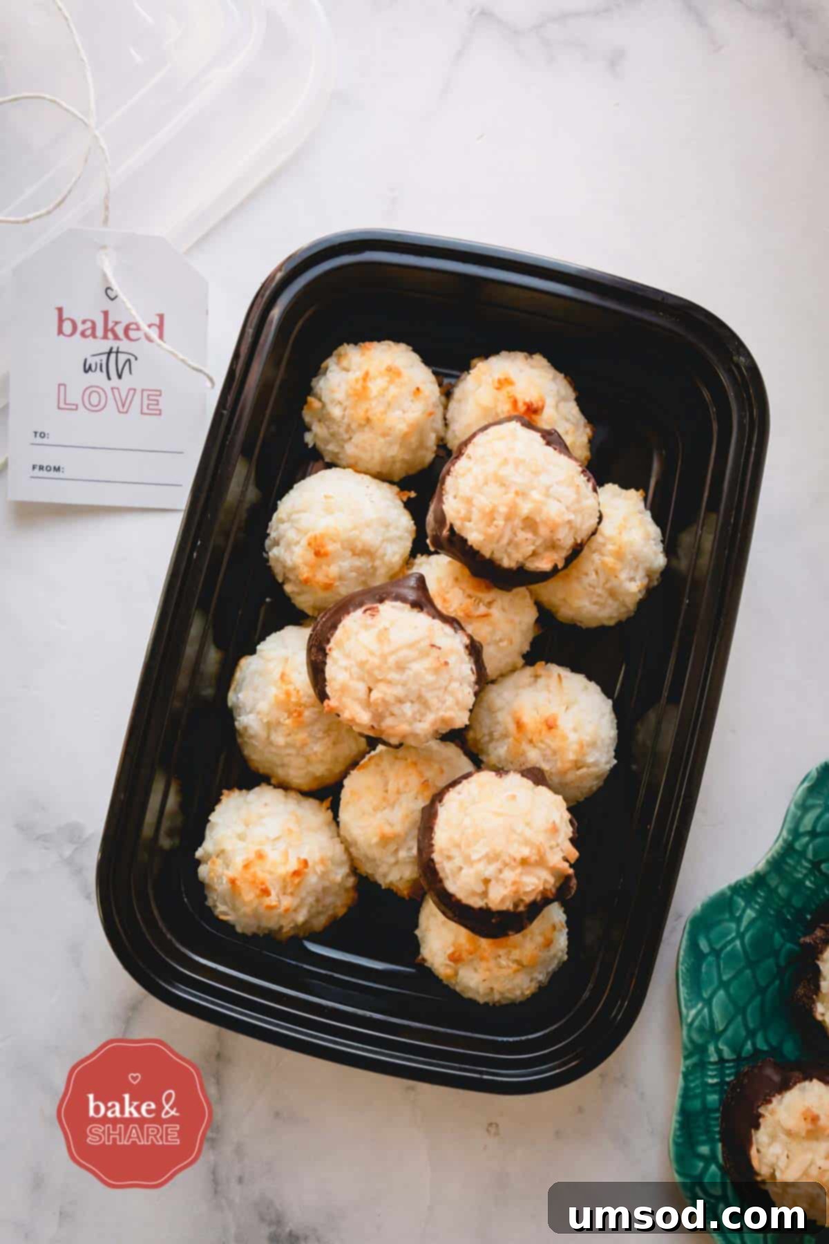 Freshly baked coconut macaroons stored neatly in a clear plastic container, demonstrating ideal storage practices for extended freshness.