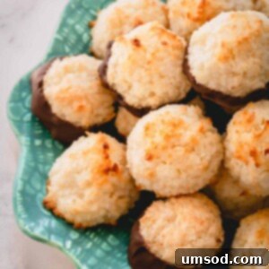 A plate of golden brown coconut macaroons, some dipped in rich chocolate, showcasing their irresistible appeal and inviting texture.