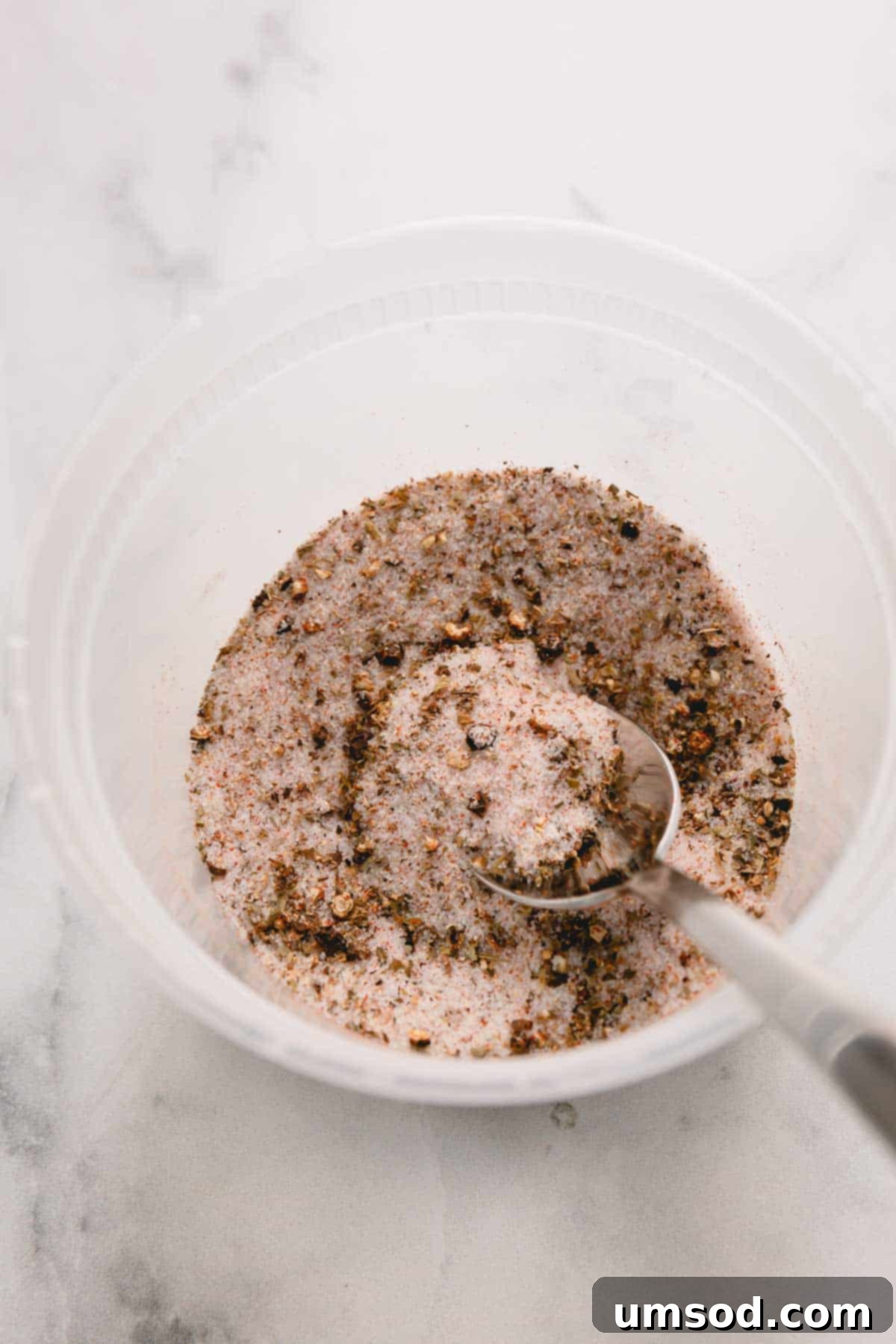 Dry brine seasoning in a plastic container.