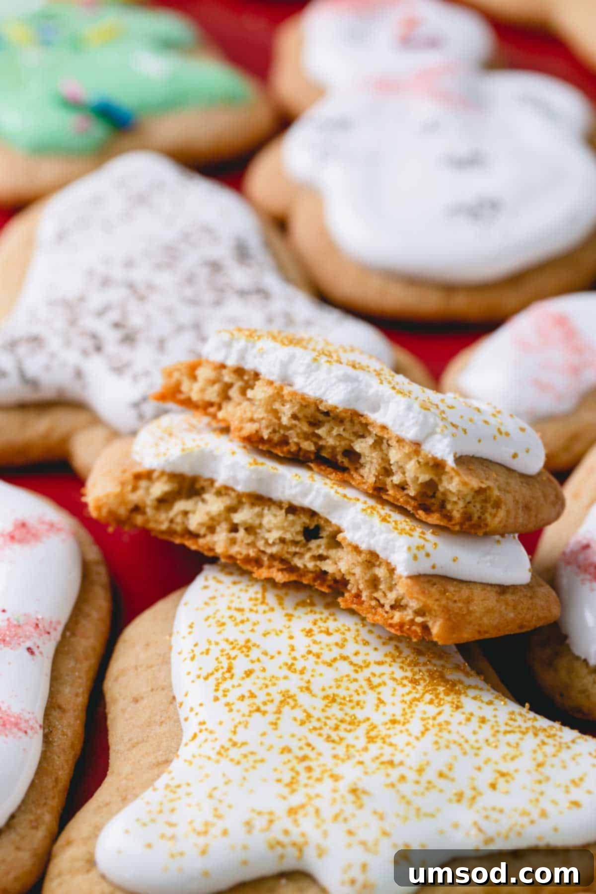 A delectable frosted honey cookie with a tempting bite taken out, perfectly showcasing its soft, tender texture and creamy icing.