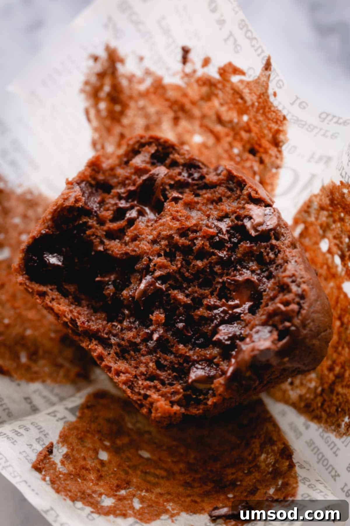 Zesty Orange Chocolate Muffins 7 A close-up view of a double chocolate orange muffin cut in half, revealing its moist, tender crumb and abundant chocolate chips.