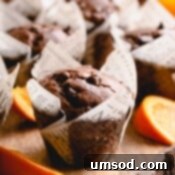 Zesty Orange Chocolate Muffins 9 orange chocolate muffins with orange slices.