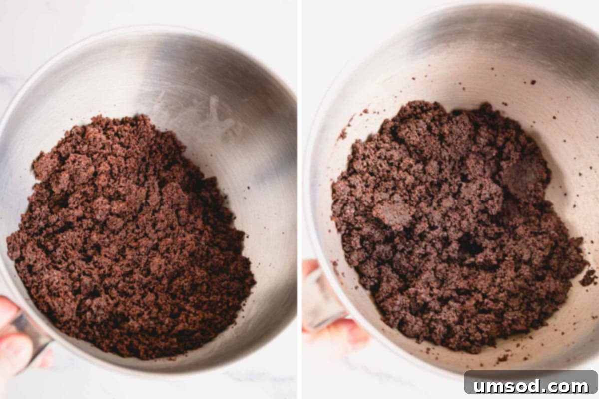 cake crumbs and frosting being mixed in a large bowl to form cake pop dough.